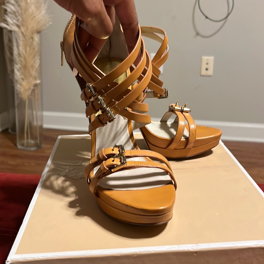 Camel colored Micheal Kors leather sandals with gold buckles and 4” heel.